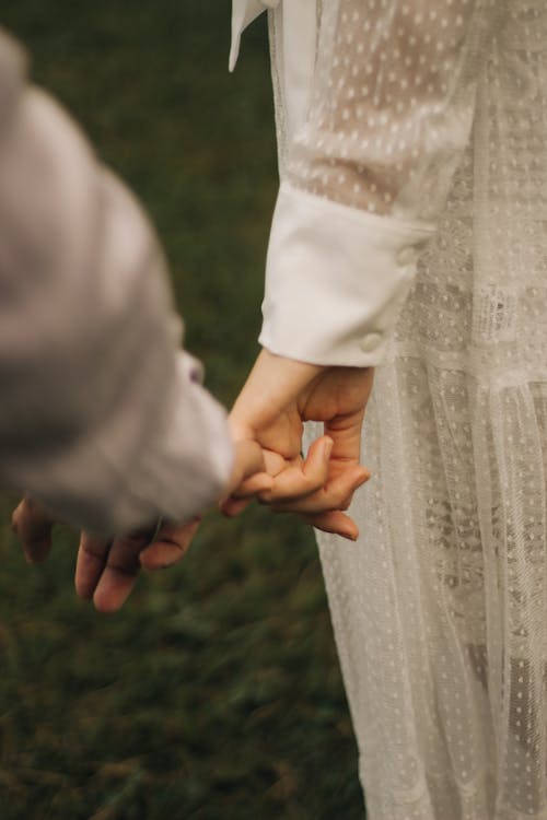 A close up of a couple holding hands