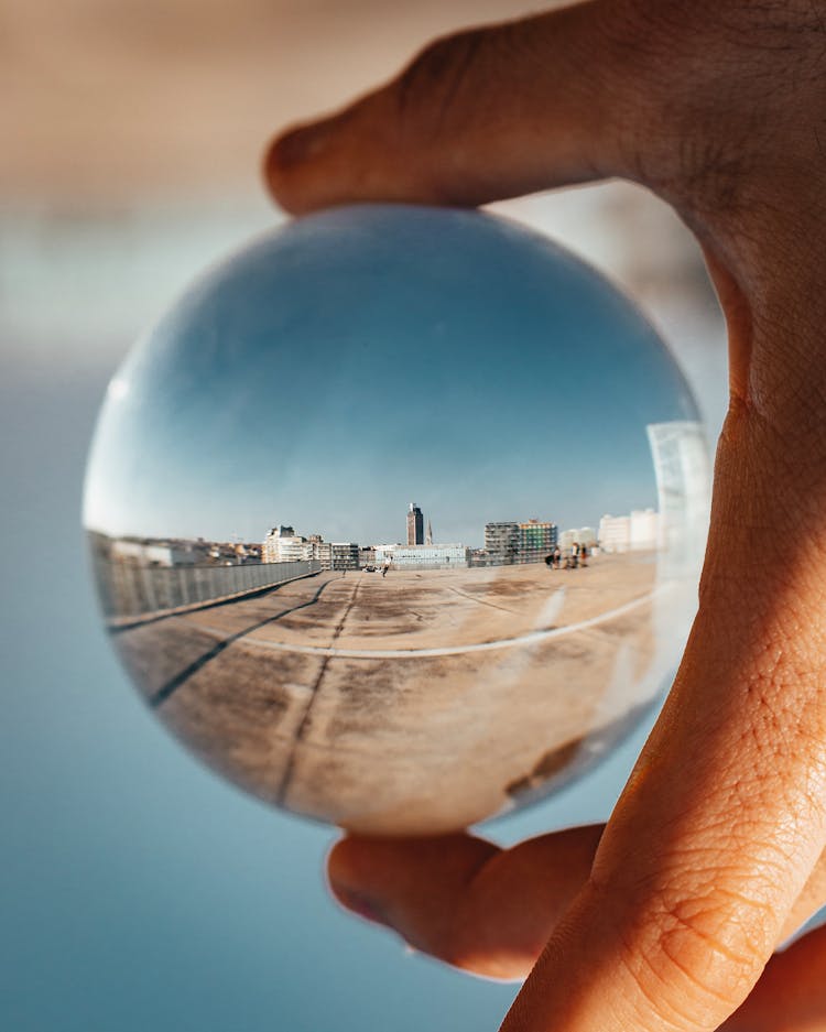 Person Holding Round Glass Ball