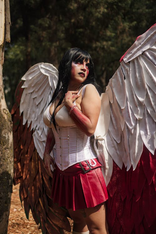 A woman dressed as an angel with wings and a red skirt