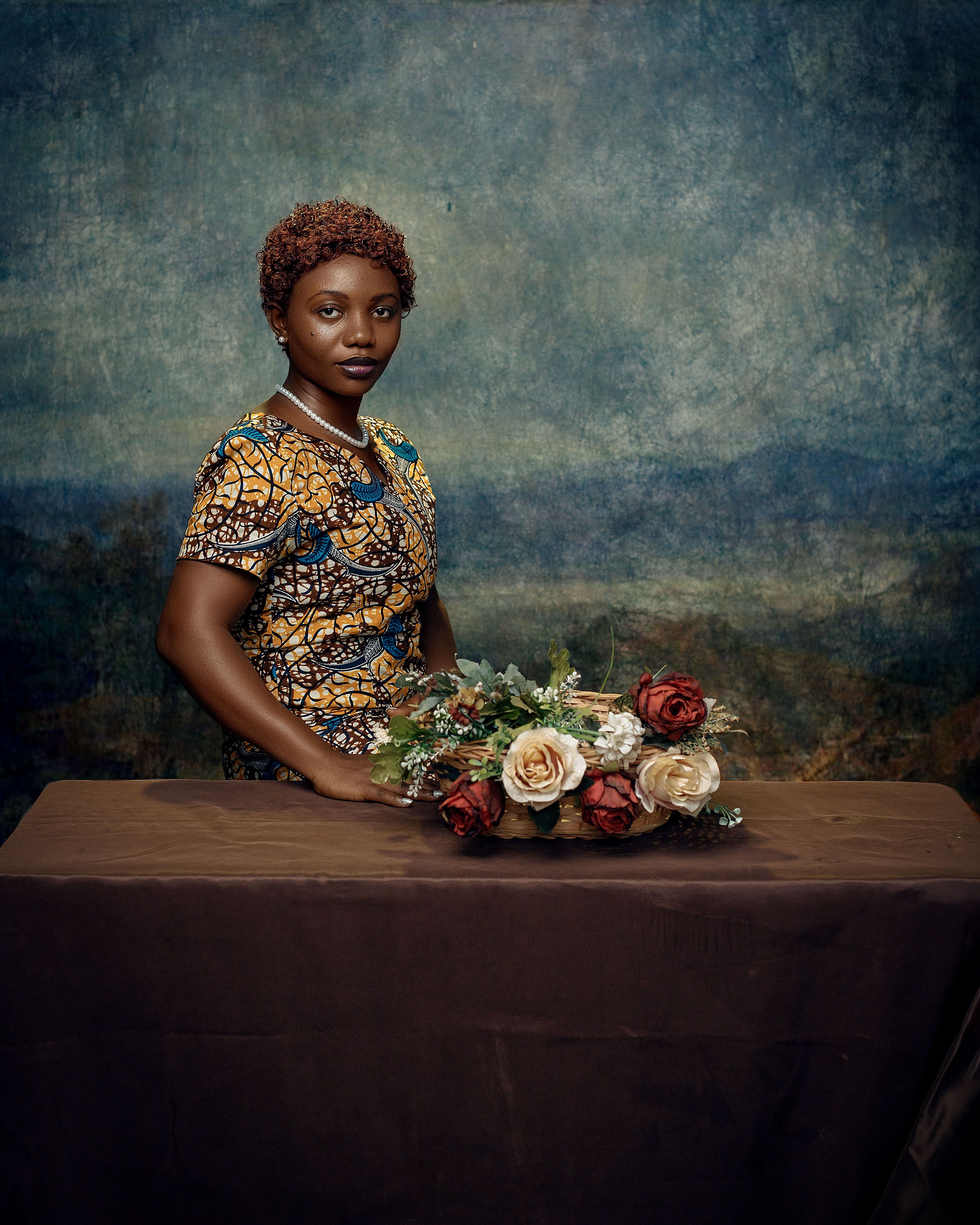 Portrait of a Ghanaian woman in traditional dress in a studio setting.