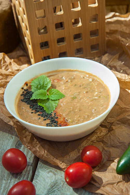 Free A bowl of soup with tomatoes, peppers and other vegetables Stock Photo