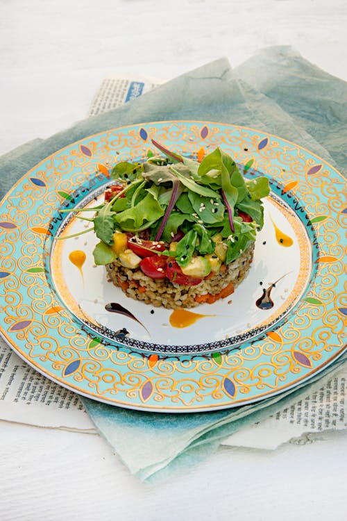 A plate with a salad on it and a fork