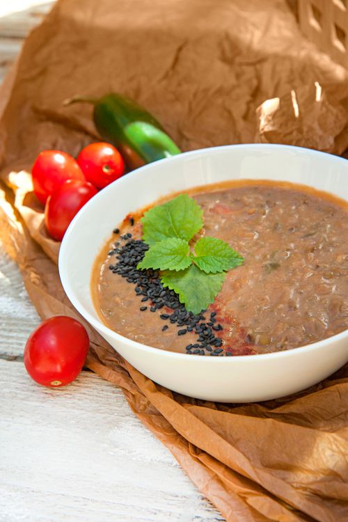Free Delicious tomato soup garnished with herbs, perfect for a comforting meal. Stock Photo