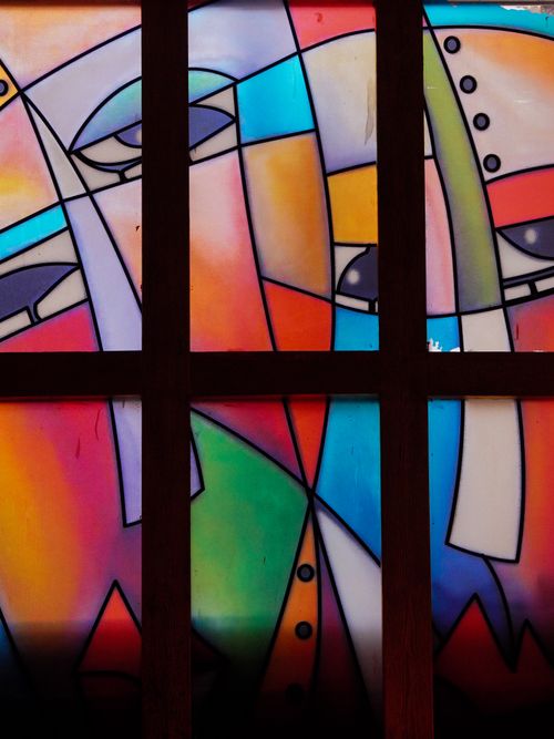 Free Vibrant abstract stained glass window design with modern art style and bold colors. Stock Photo
