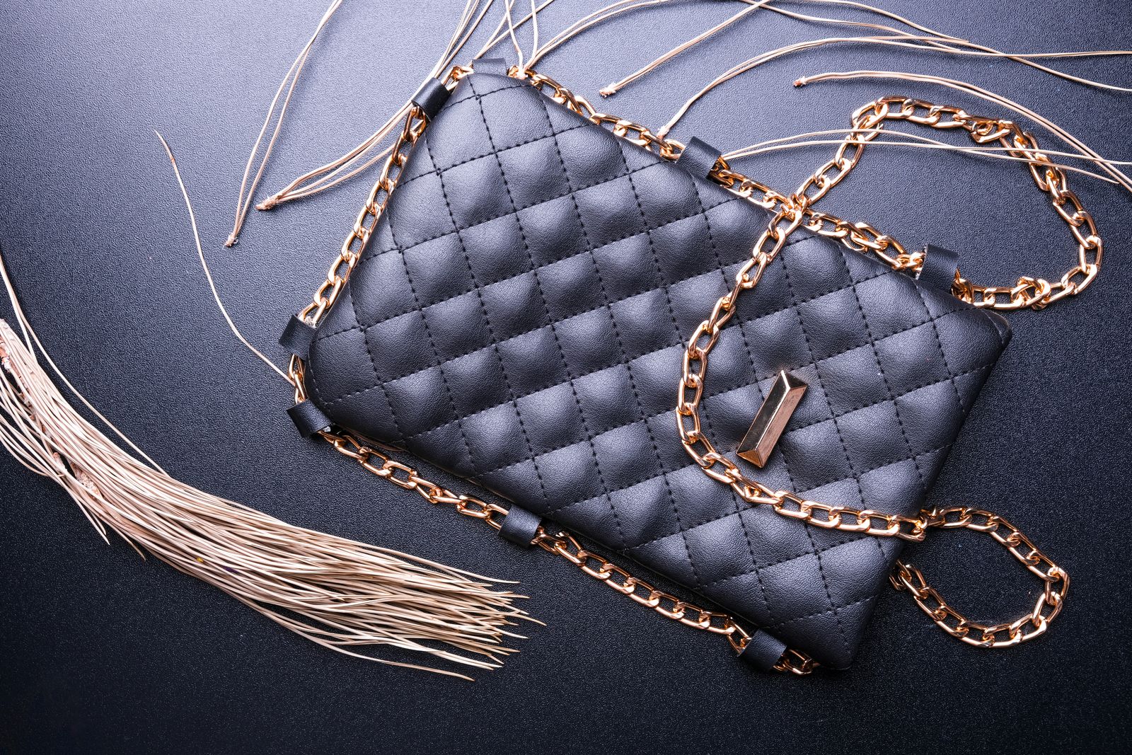 Black quilted purse with golden chain strap