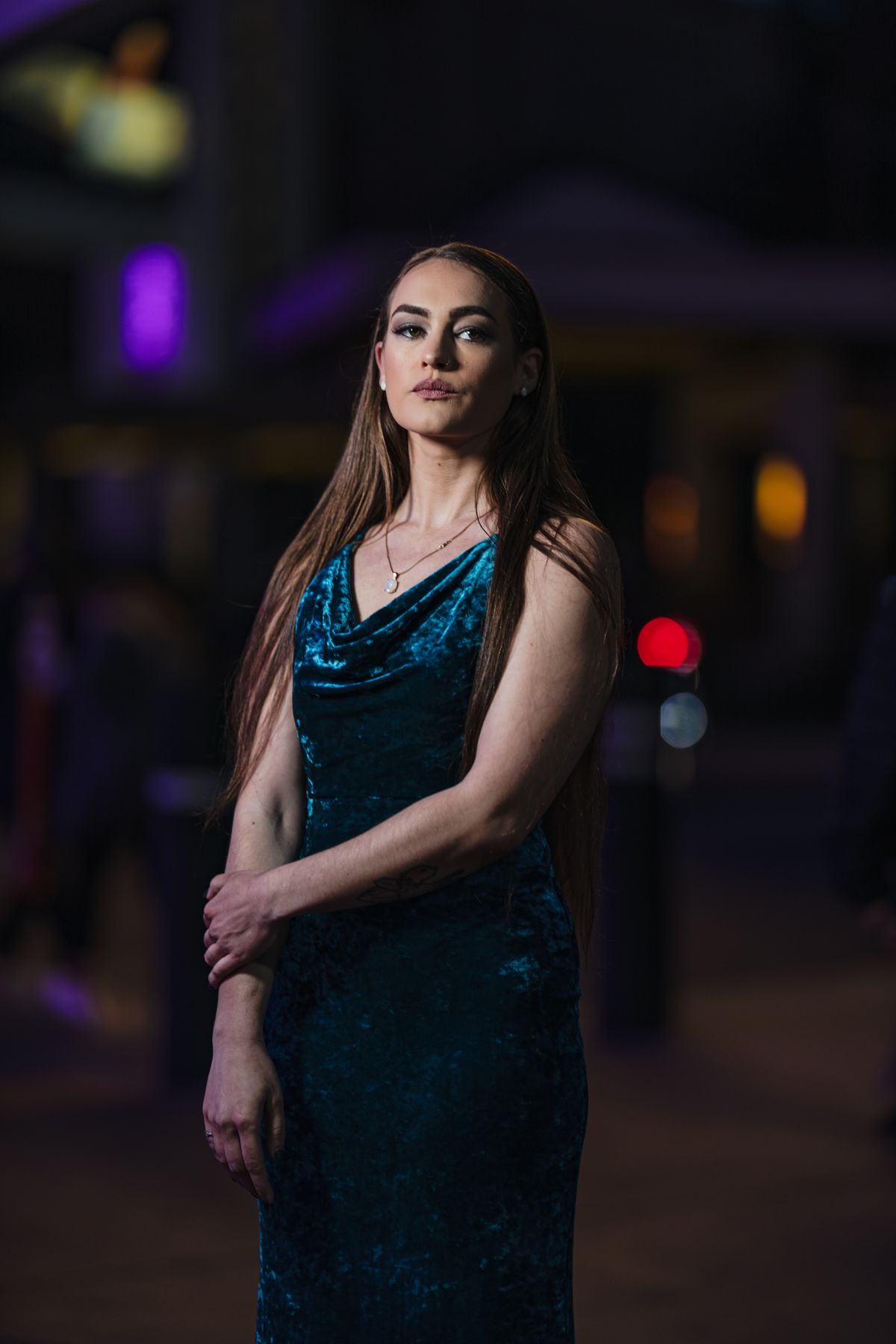 Young woman wearing a blue velvet evening gown as a festive holiday party outfit