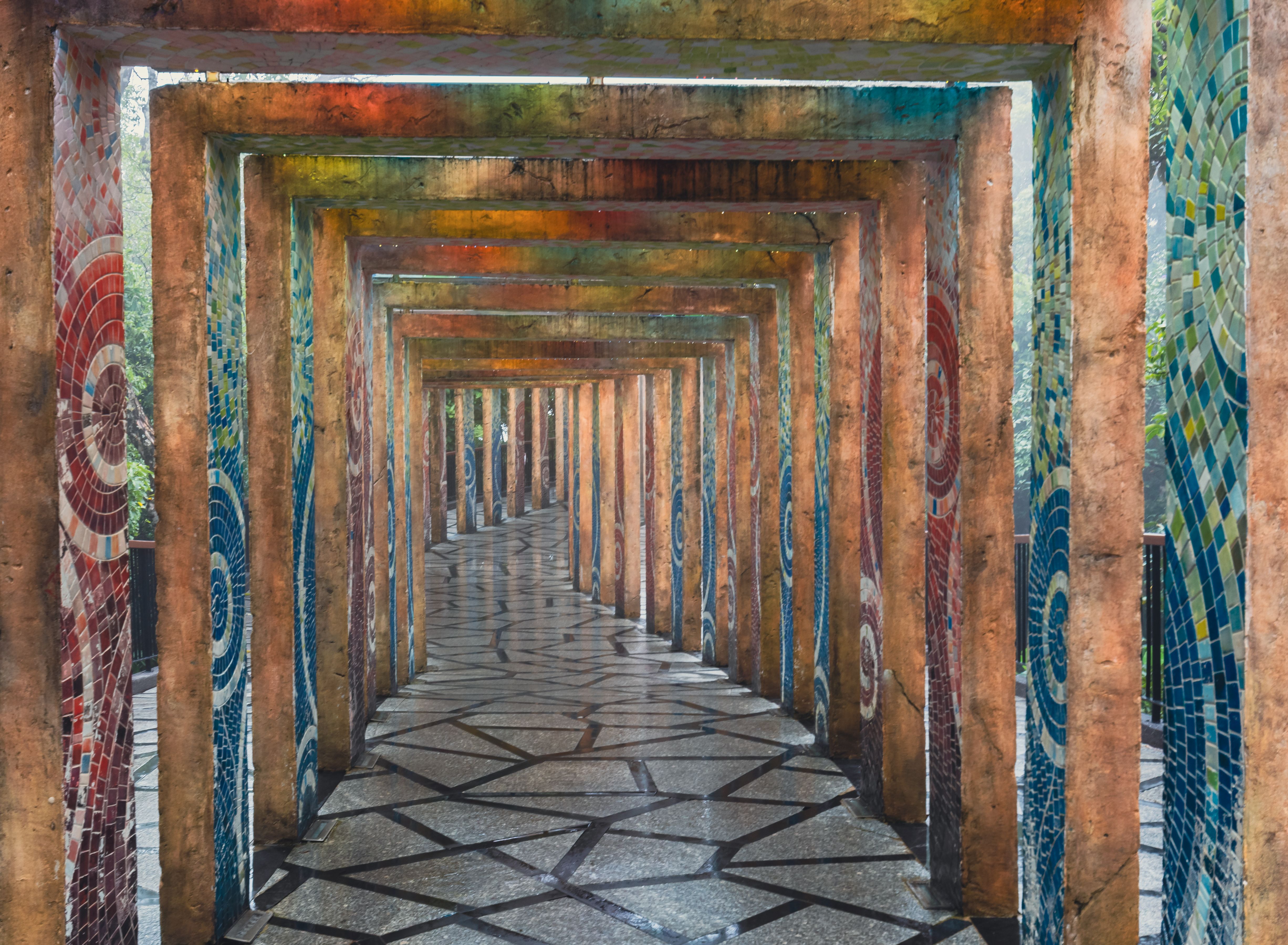 A vibrant mosaic corridor with geometric paving stones in Ba Na Hills, Vietnam.