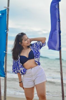 Portrait of a woman in summer fashion on Rayong Beach, Thailand.