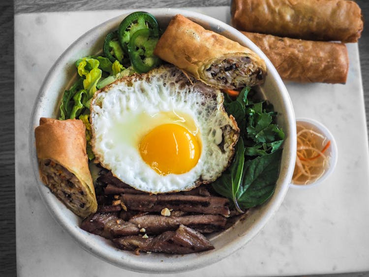 Bowl Of Fried Food And Fried Egg