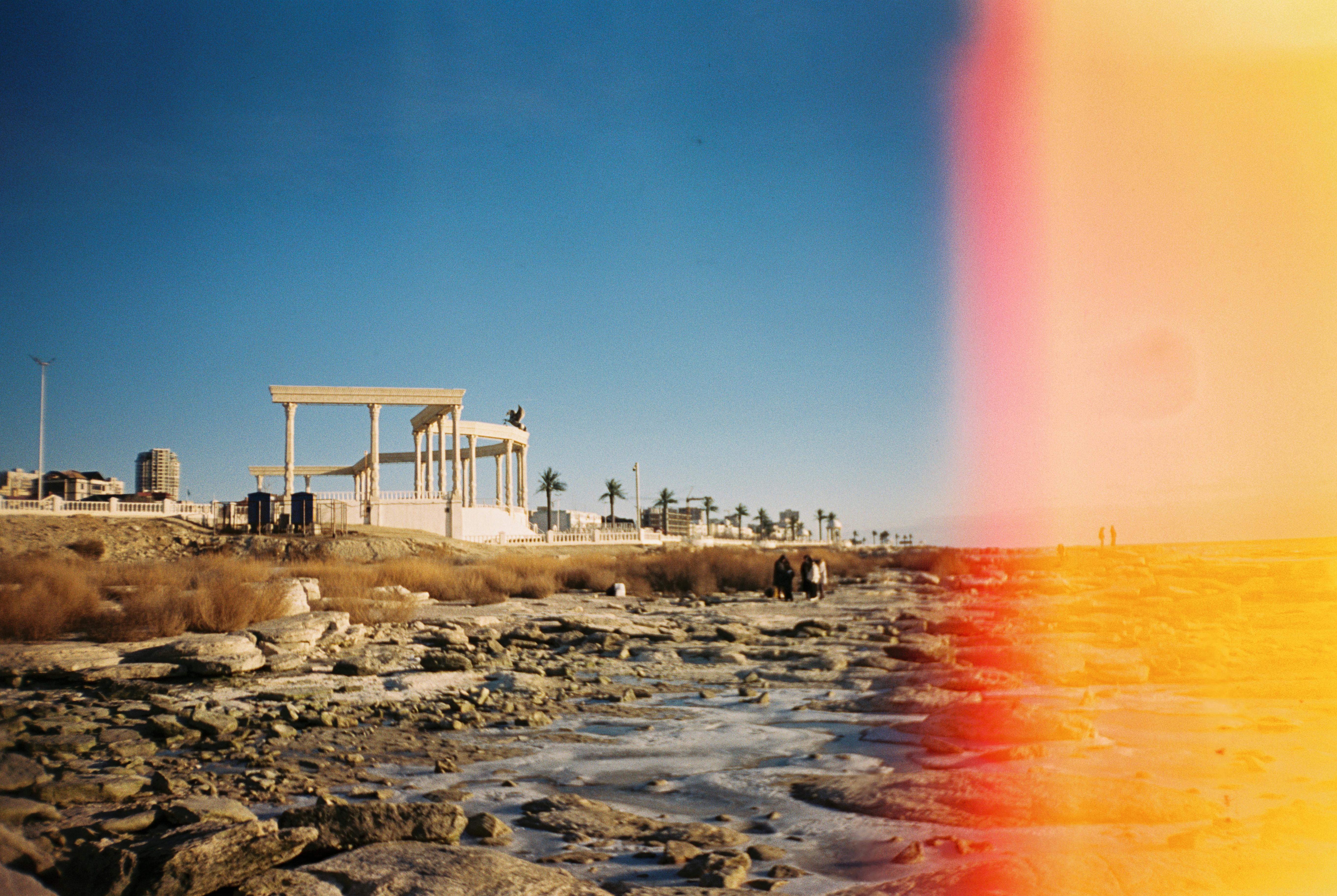 Explore the rocky shore and architectural ruins by the Caspian Sea in Aktau, Kazakhstan.