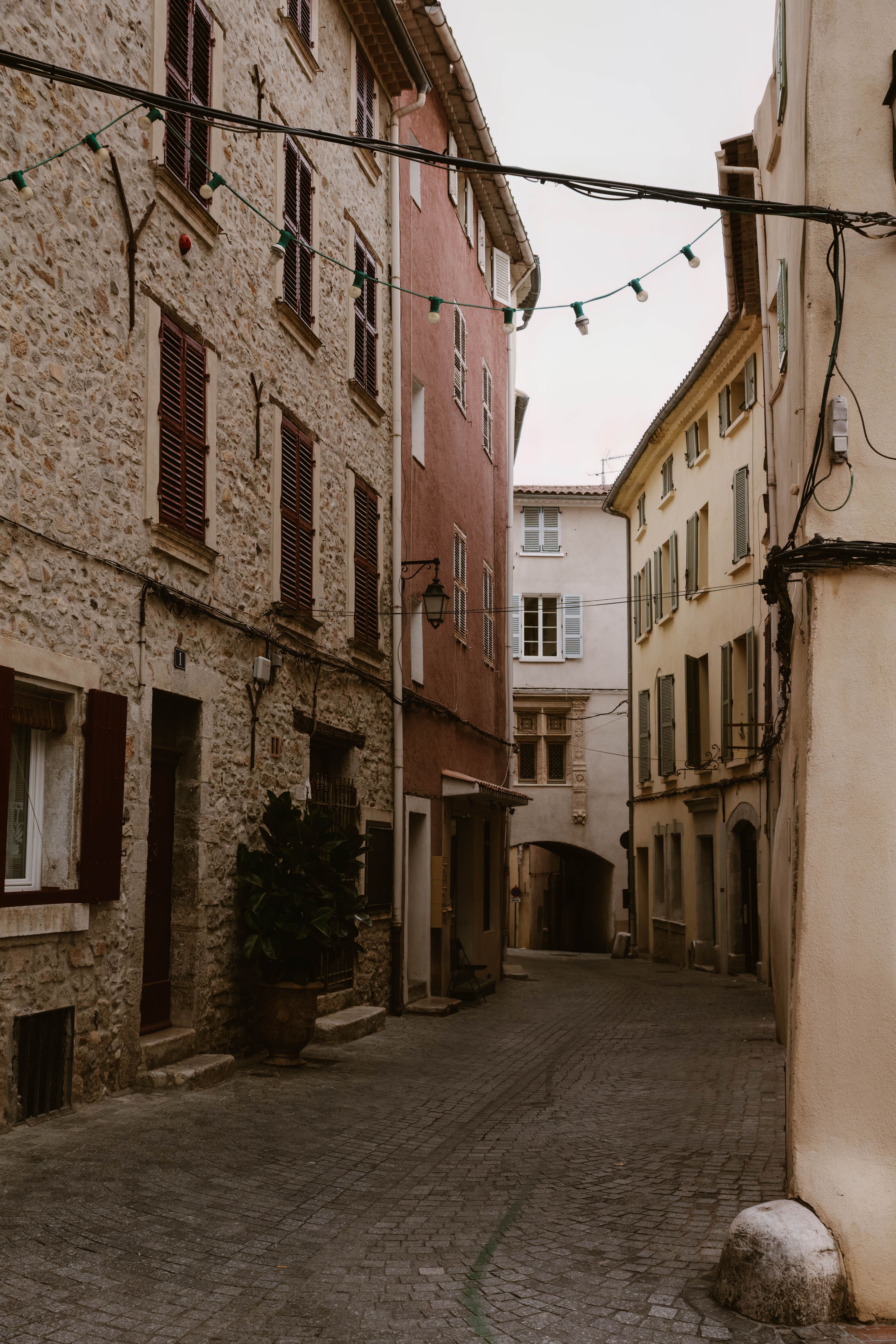 Explore the quiet charm of a narrow alley in Le Revest-les-Eaux, France, showcasing traditional architecture.