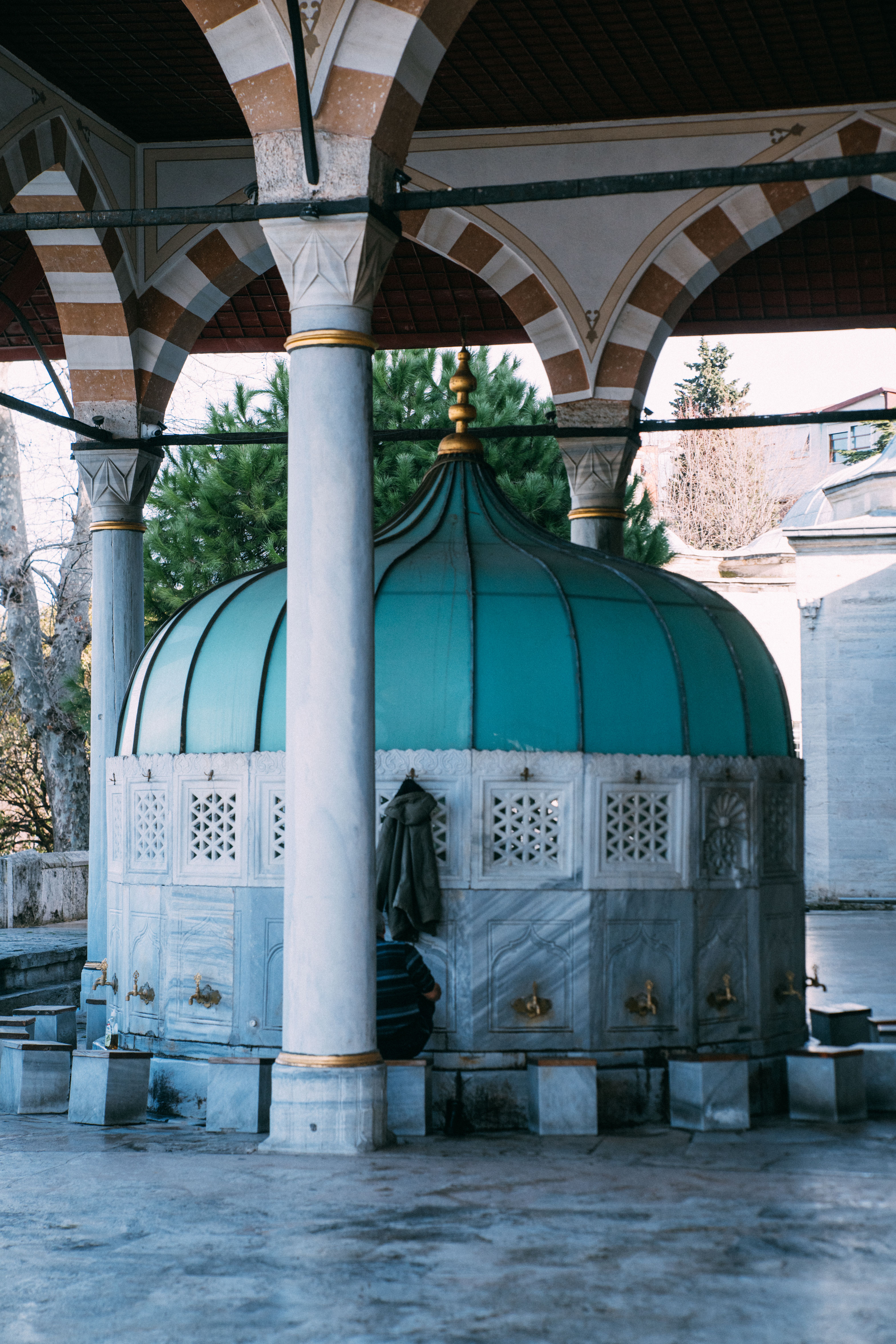 Outdoor ablution fountain at Mihrimah Sultan Mosque showcasing Islamic architecture.