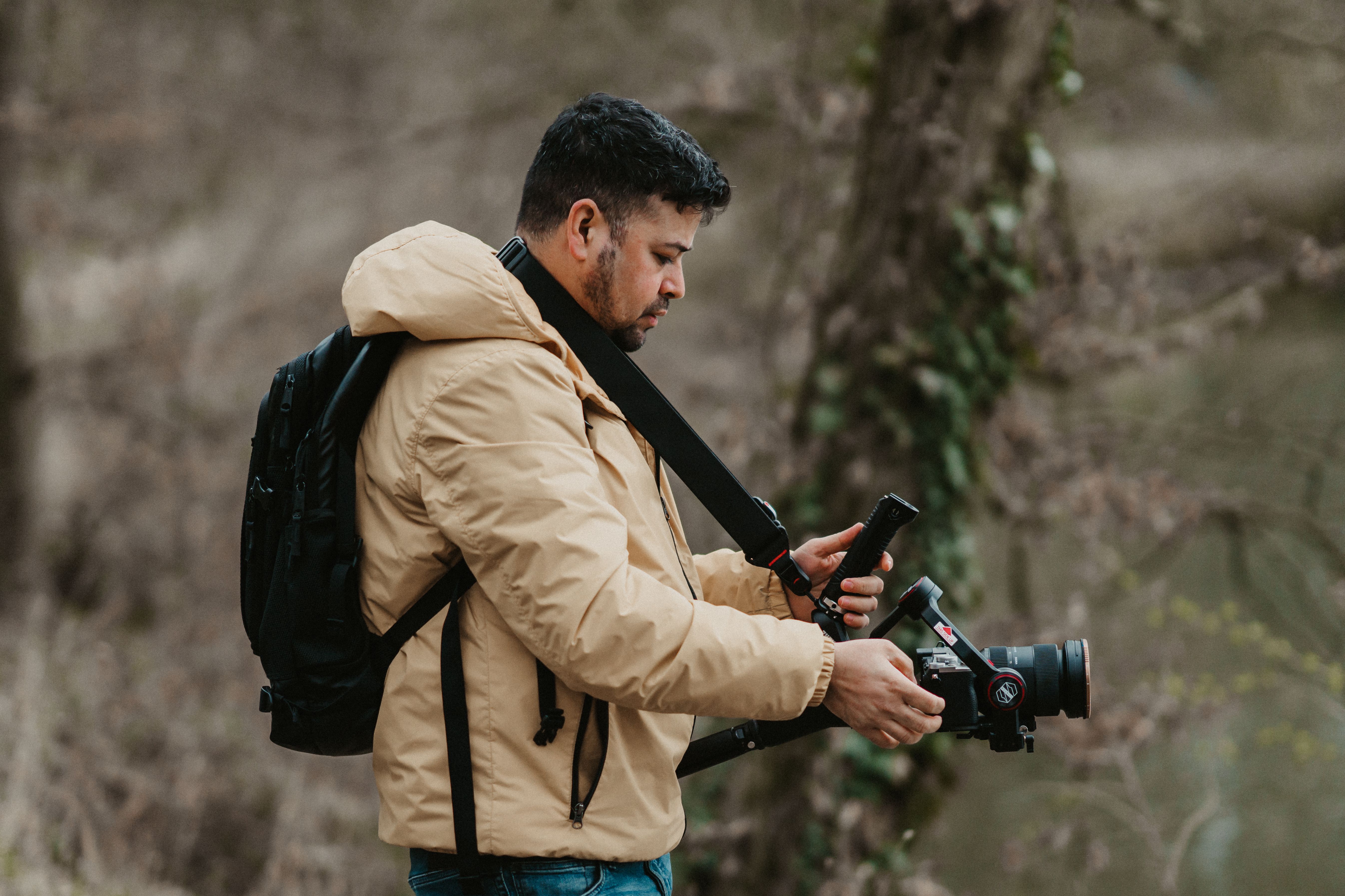 photographer with professional camera backpack in outdoor setting - best photography gear