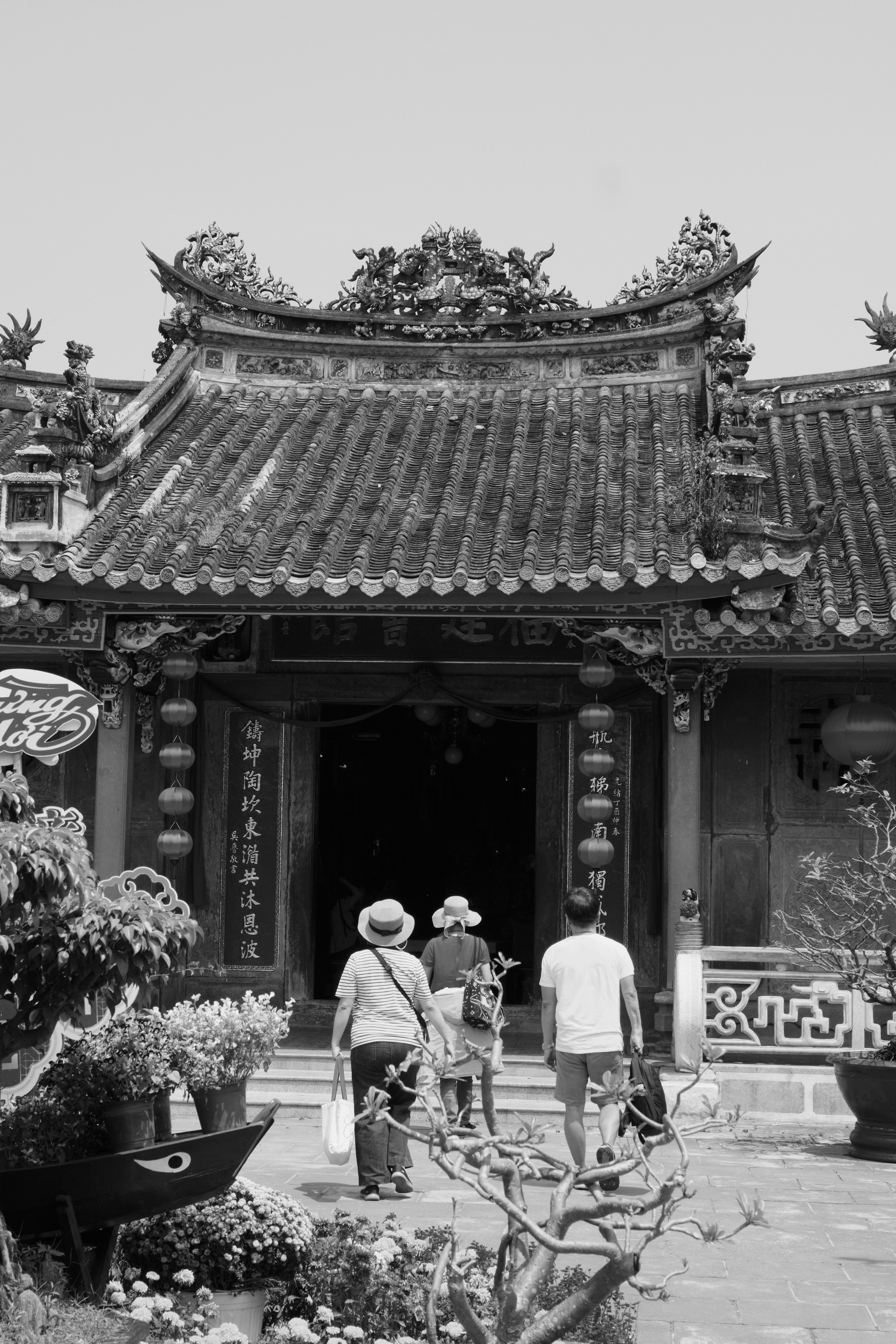 Visitors explore a historic temple in Hội An, Vietnam. Traditional architecture captures cultural essence.