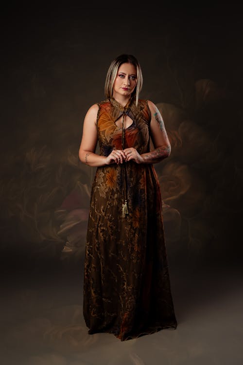 A woman in a long dress posing for a portrait