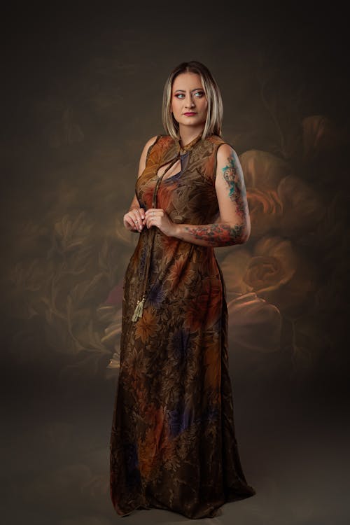 A woman in a long dress posing for a portrait