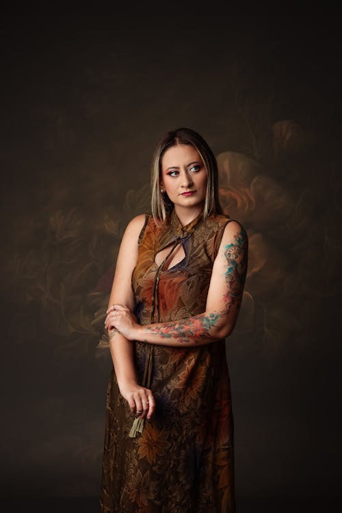 A woman with tattoos posing for a portrait