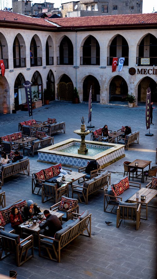 People Sitting at the Tables on a Cafe Patio at Mecidiye Han, Gaziantep, Turkey 