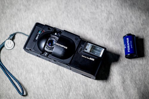 A camera with a battery and a camera strap