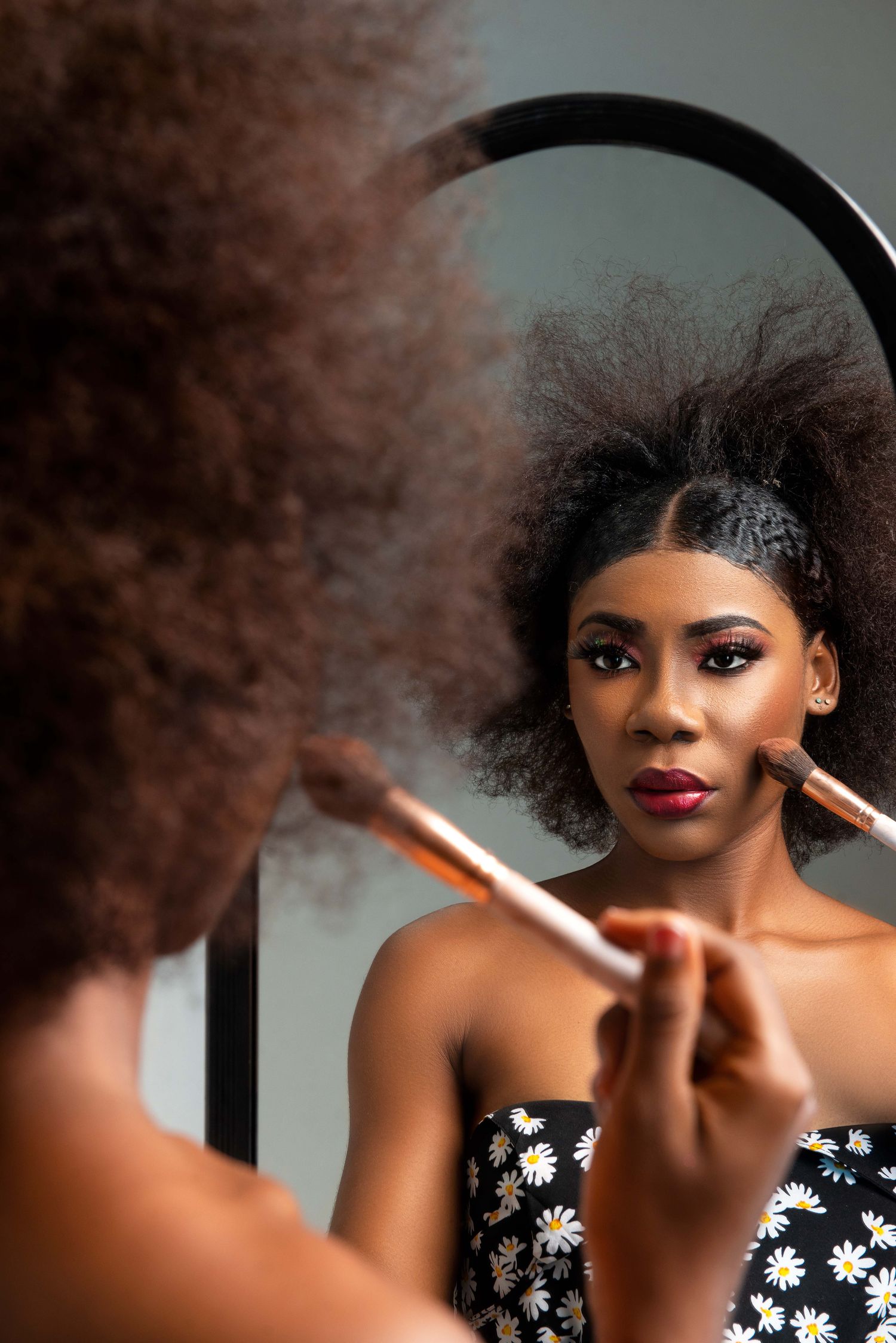 Woman applying makeup in front of a mirror, illustrative stock imagery
