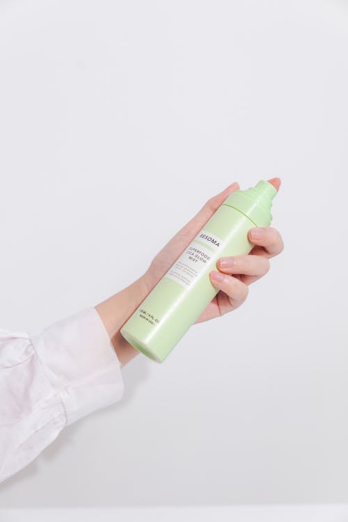 Hand model holding spray bottle