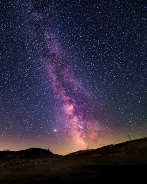 The milky way is seen in the sky above a desert
