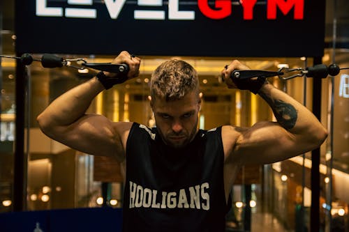 A man holding a bar with the words level gym