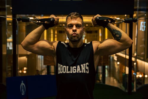 A man in a gym with a barbell in his hand