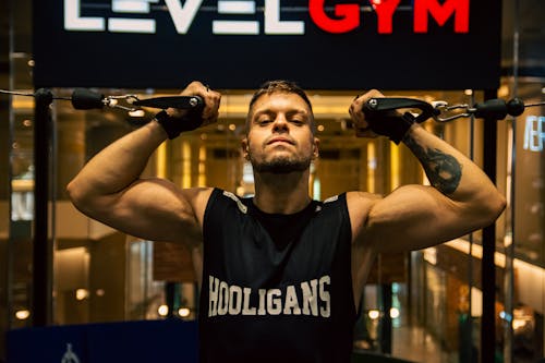 A man holding a bar with the words level gym