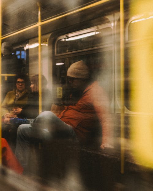 A blurry image of people on a subway train