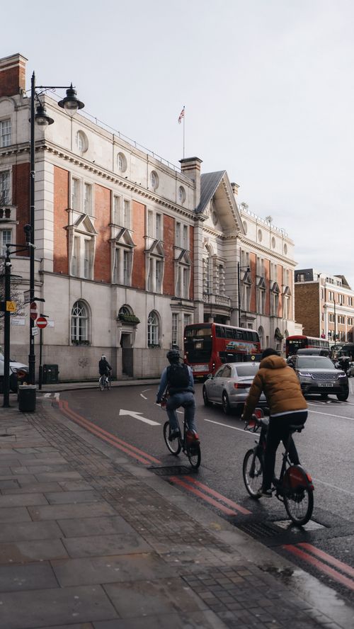 Free Cyclists commuting in an urban London street surrounded by classic architecture and busy traffic. Stock Photo
