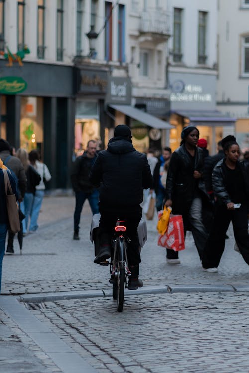 A man riding a bike on a busy street