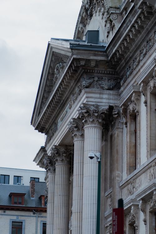 Free Intricate facade and columns of a historic building in Brussels showcasing eclectic architecture. Stock Photo