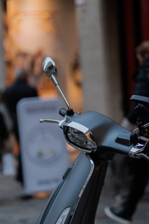 A close up of a scooter parked on a street