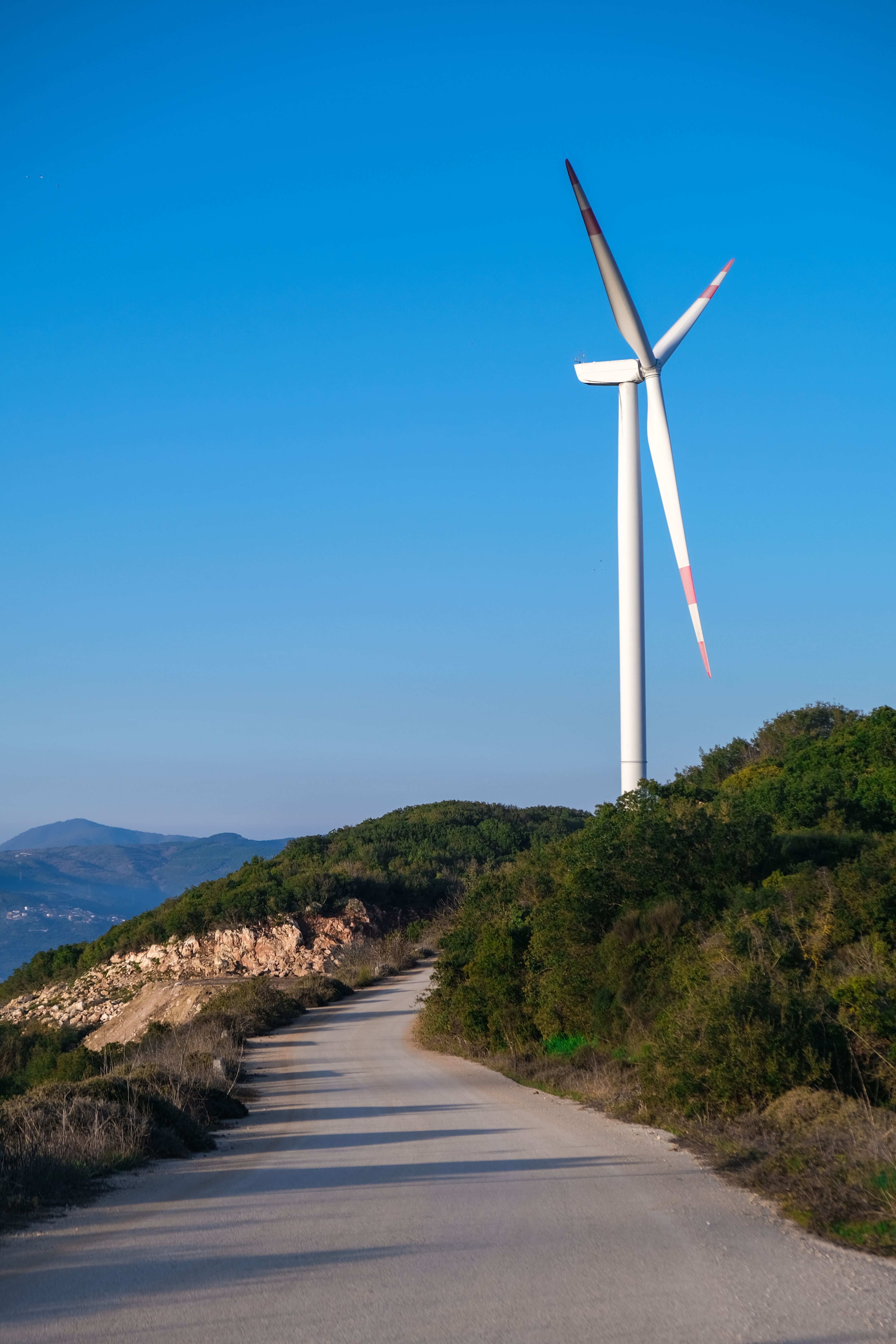 Landscape with a Wind Turbine against Blue Sky · Free Stock Photo