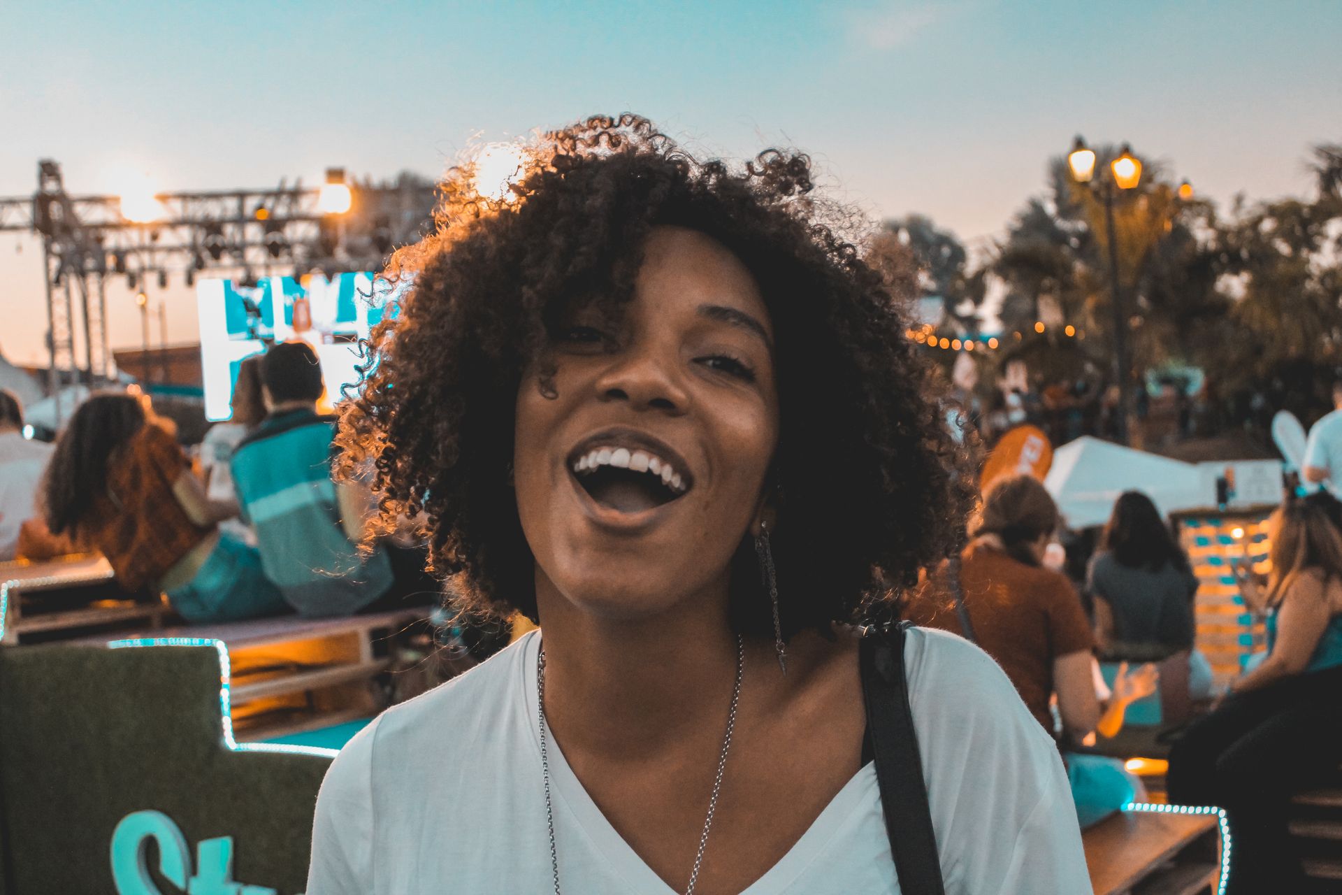 Happy woman at an outdoor festival in Panama City with a vibrant atmosphere.