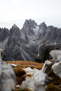 Stunning view of rugged rocky mountains with cloudy sky, showcasing natural beauty and erosion.