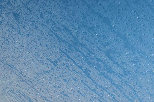 A blue and white background with water droplets