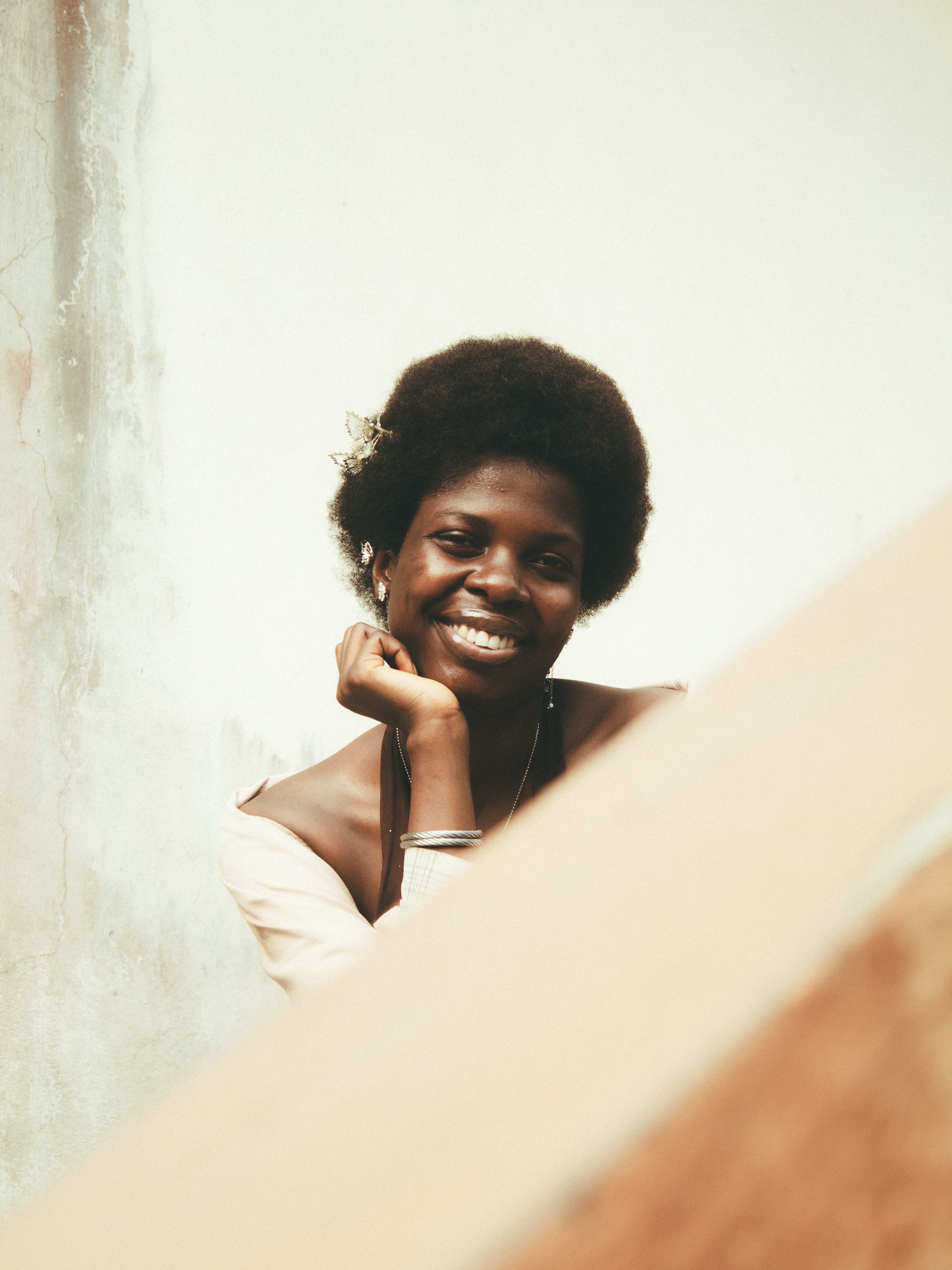 Smiling Woman with Hand on Chin · Free Stock Photo
