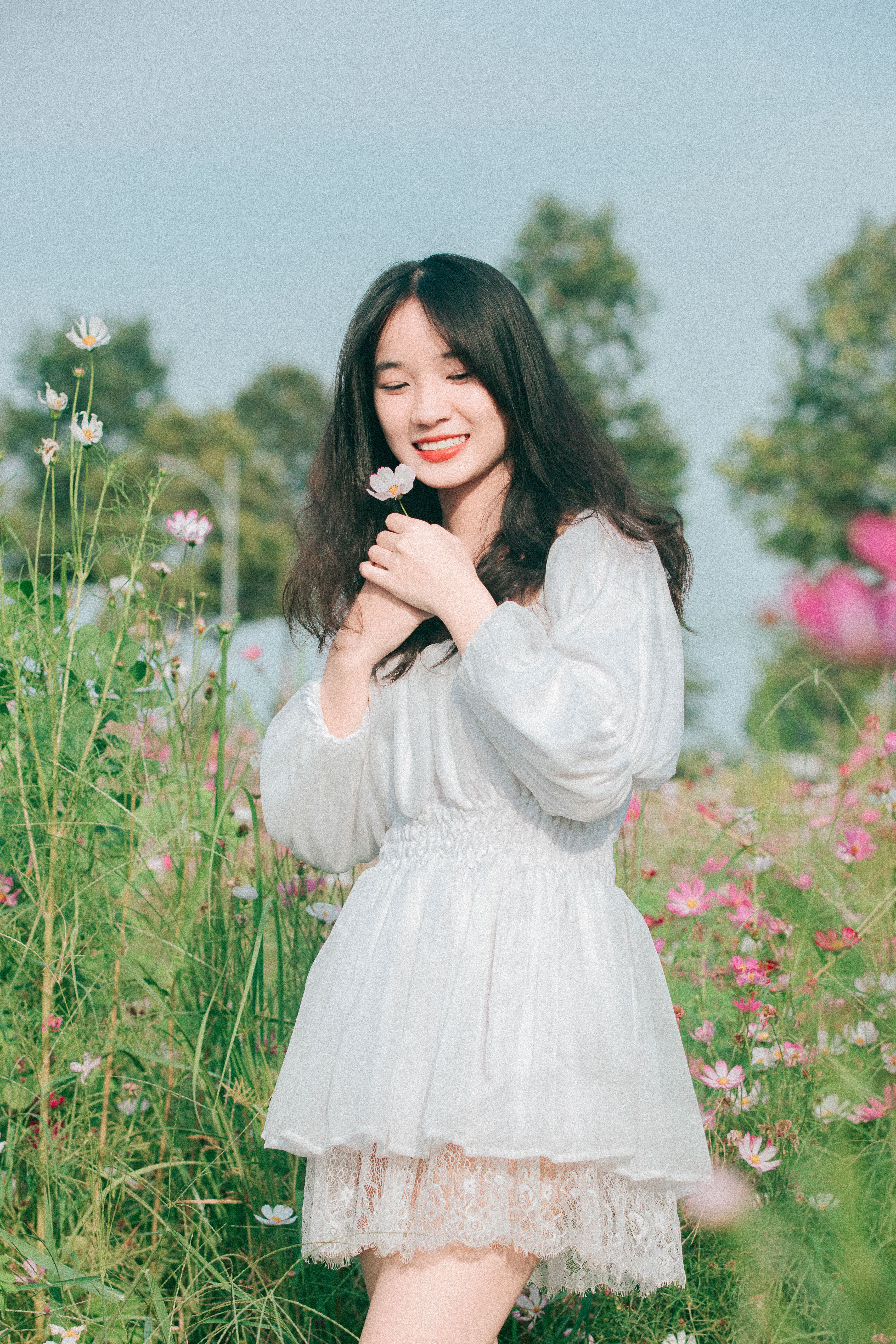 Young Woman in a White Dress Standing on a Meadow and Smiling · Free ...