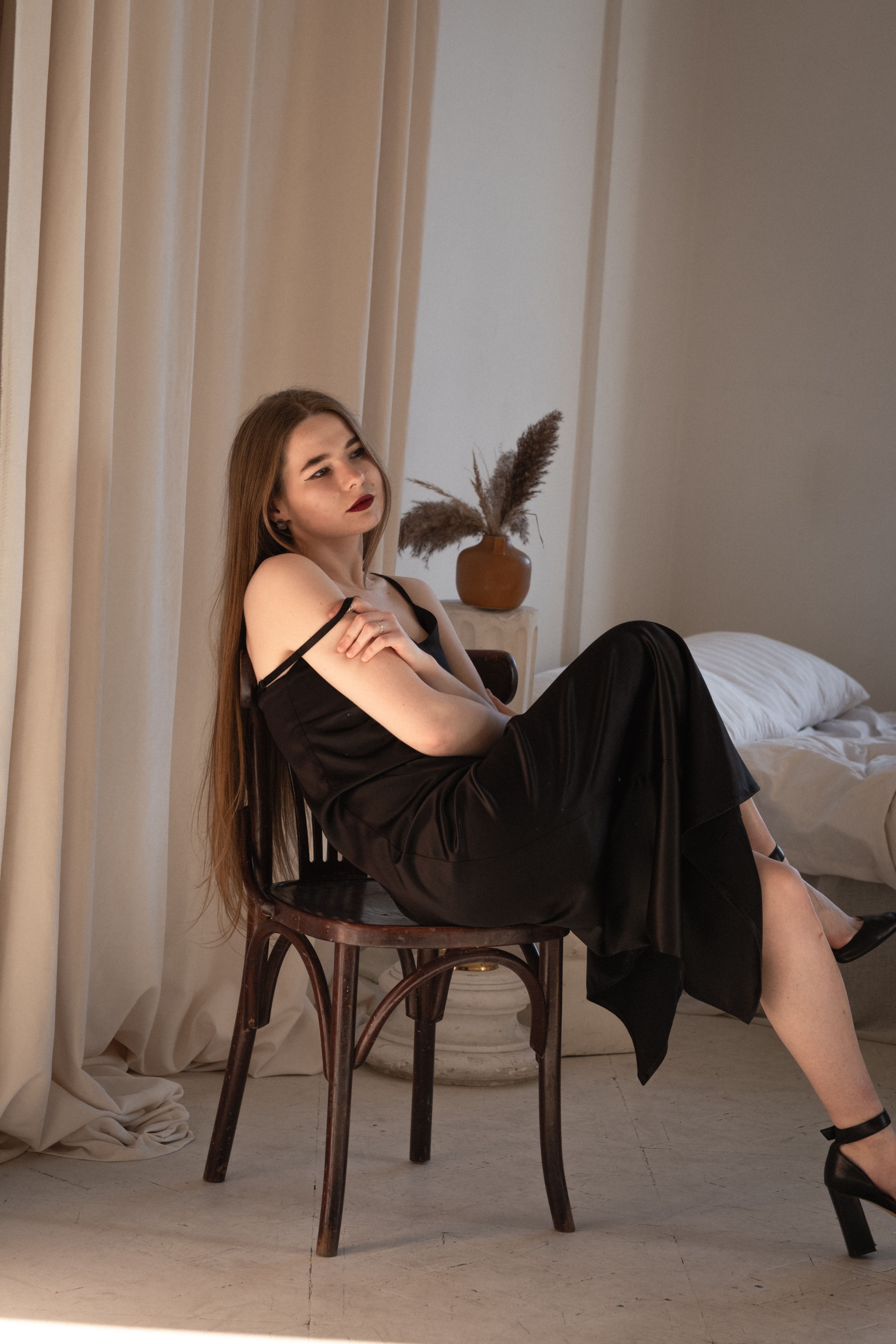 Young Woman in a Black Dress Sitting on a Chair · Free Stock Photo