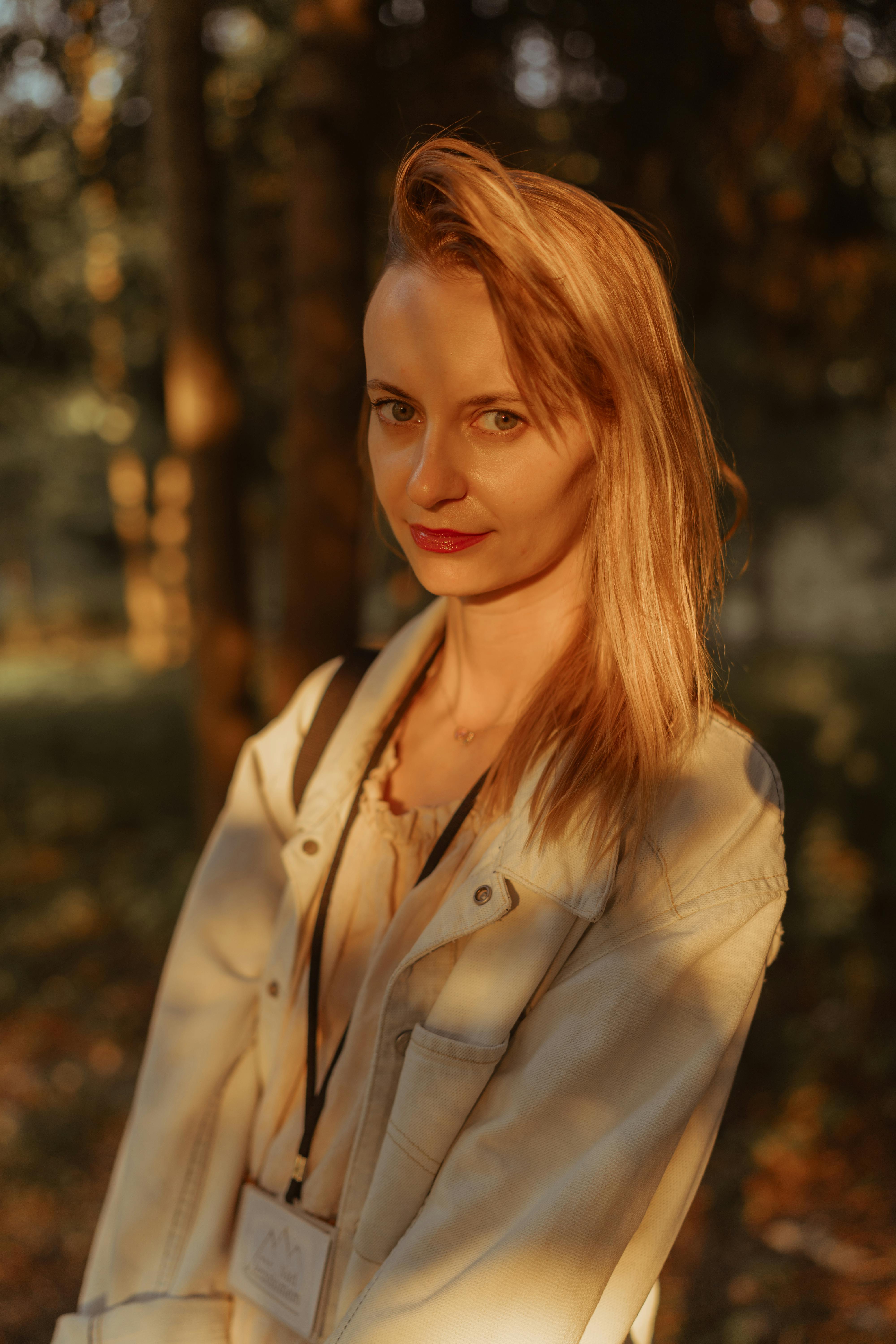 A captivating portrait of a woman during golden hour in a scenic forest in Sromowce Niżne, Poland.