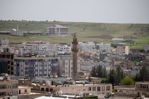 Free Explore the vibrant Midyat cityscape with historic architecture and lush surroundings in Mardin, Türkiye. Stock Photo