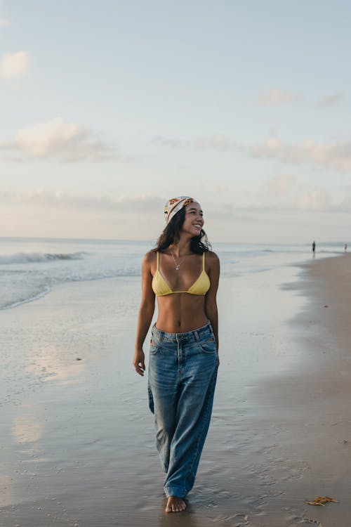 Smiling Brunette Woman in Bra Walking on Beach