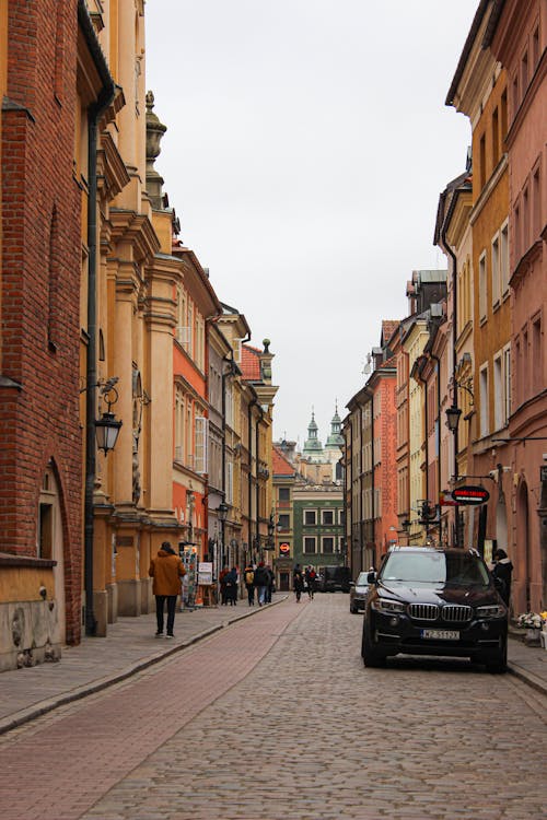 A cobblestone street with a car parked on it