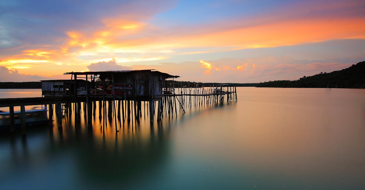 Wooden House in Body of Water during Sunset Photo
