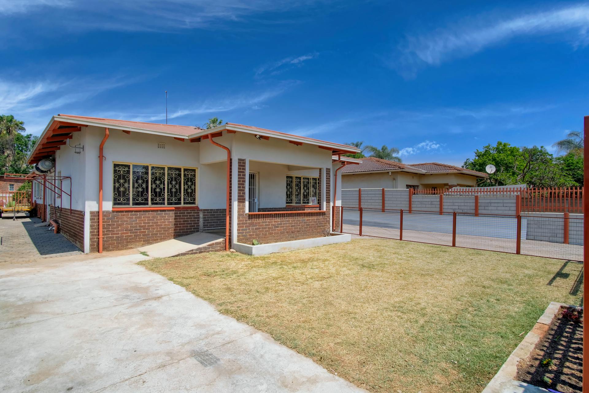 Cozy brick house with garden, set in a sunny rural Pretoria neighborhood.