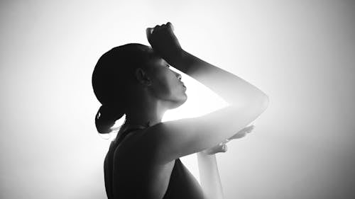 Light over Woman Standing with Hand Raised