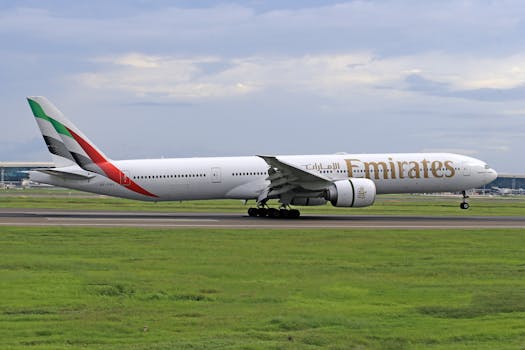 Emirates jet captured during takeoff on a clear day at the airport runway.