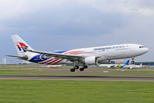 Malaysia Airlines Airbus A330 taking off with blurred background of airport.